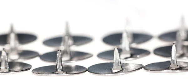 Rows of isolated metal pins on white — Stock Photo, Image