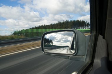 Landscape in the mirror of a car clipart