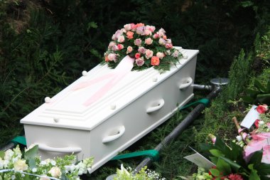 White coffin with pink sympathy flowers clipart