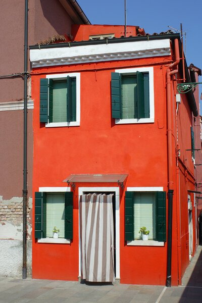 Bright red house on the island of Burano in the Venice lagoon