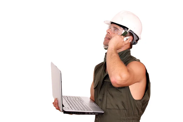 Oil worker with laptop and phone — Stock Photo, Image