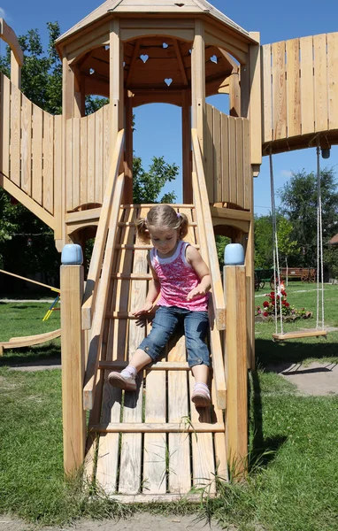 Little girl fun on wooden playground — Stock Photo, Image