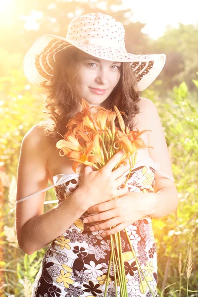 Female with flowers outdoors — Stock Photo, Image