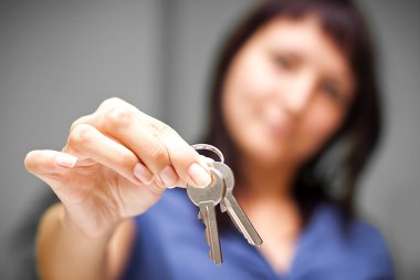 Realtor in empty apartment giving keys clipart