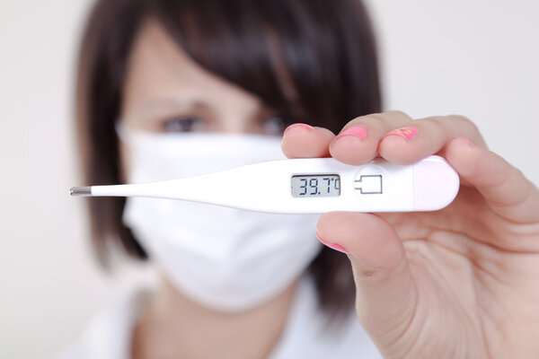 Female doctor holding medical thermometer