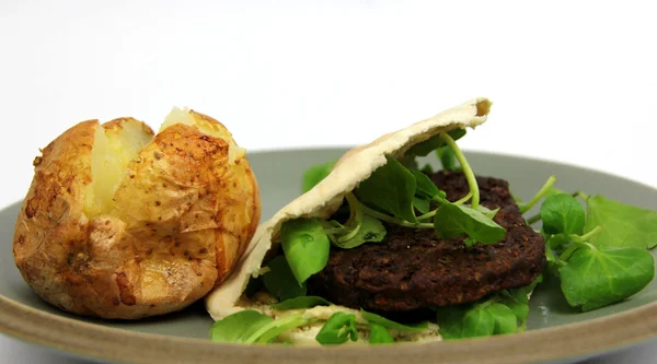 Plain Baked Potato, a vegetarian burger in Pitta bread — Stock Photo, Image