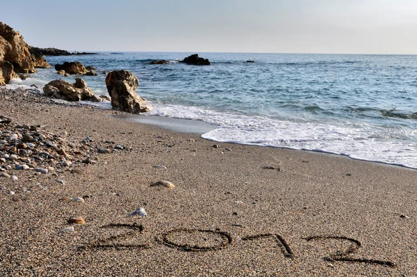 2012 escribir en la arena en la playa —  Fotos de Stock