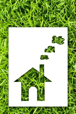Paper house on fresh grass land. clipart