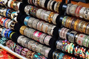 Rows of colorful bracelets on jewelry market clipart