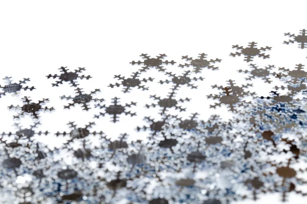Confetti snowflakes on white background — Stock Photo, Image