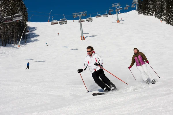 Two skiers downhill skiing — Stok fotoğraf