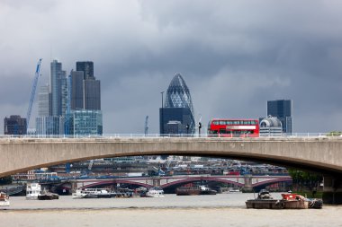 Bus on Waterloo Bridge in front of the London City clipart