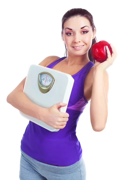 Kobieta z wagą i jabłko — Zdjęcie stockowe