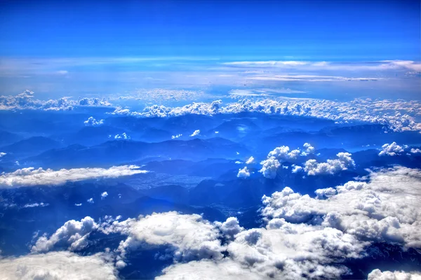 High in the sky, puffy white clouds — Stock Photo, Image