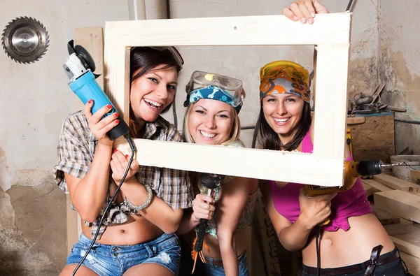 Sexy girls in the carpentry shop carpenters — Stock Photo, Image