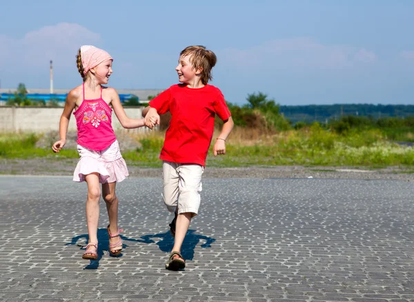 Happy little kids running in street — Stock Photo, Image