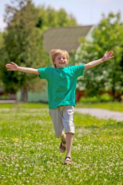 Little boy running in park clipart