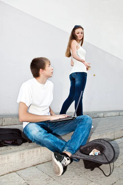 Girl throwing coins unemployed young programmer — Stock Photo, Image