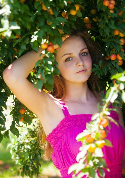 Красивая молодая девушка в белом розовый отдых в саду сливы — стоковое фото