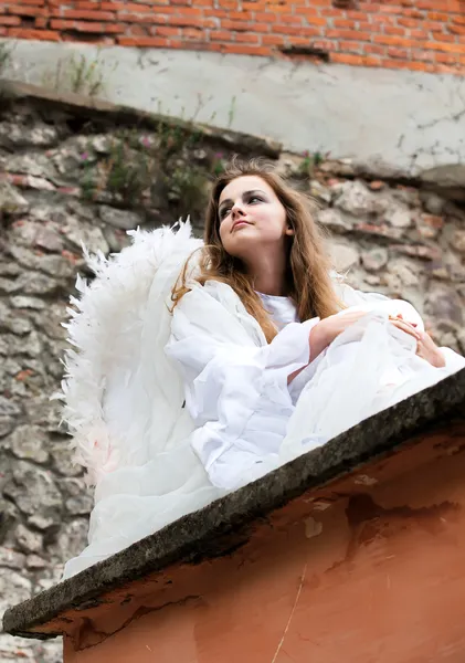 Angel sitting on a roof of the old castle — Stock Photo, Image