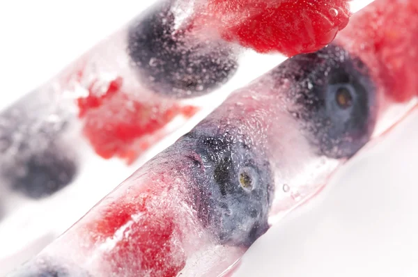 stock image Raspberry and blackberry frozen in ice sticks