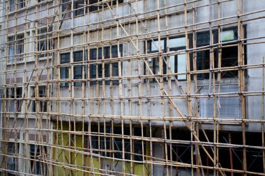 Bamboo scaffolding in front of the building.