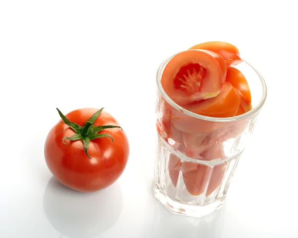 Tomato and slices in glass isolated on white background — Stock Photo, Image