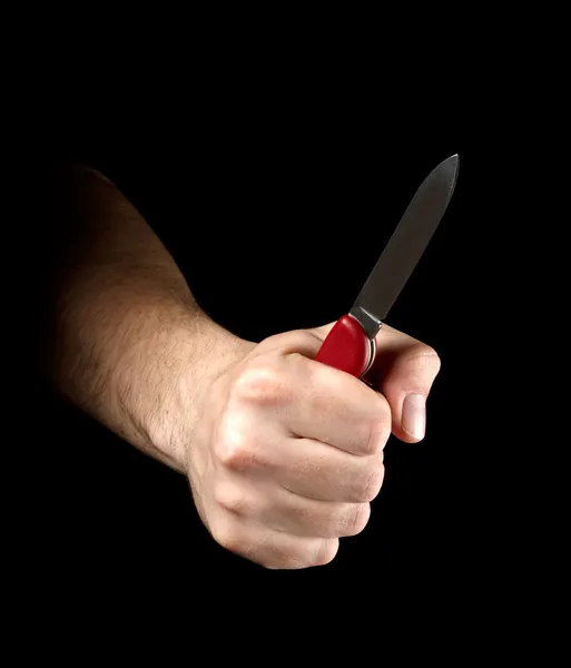 Knife in hand isolated on black background — Stock Photo, Image