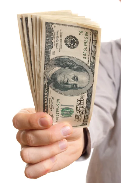 Бизнесмен держит стопку долларов — стоковое фото