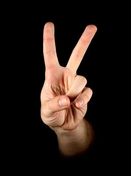 Mão mostrando vitória cantar no fundo preto — Fotografia de Stock
