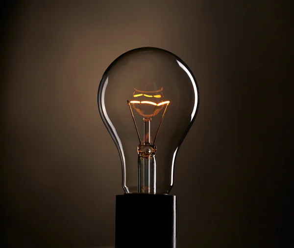 Light bulb over dark background — Stock Photo, Image