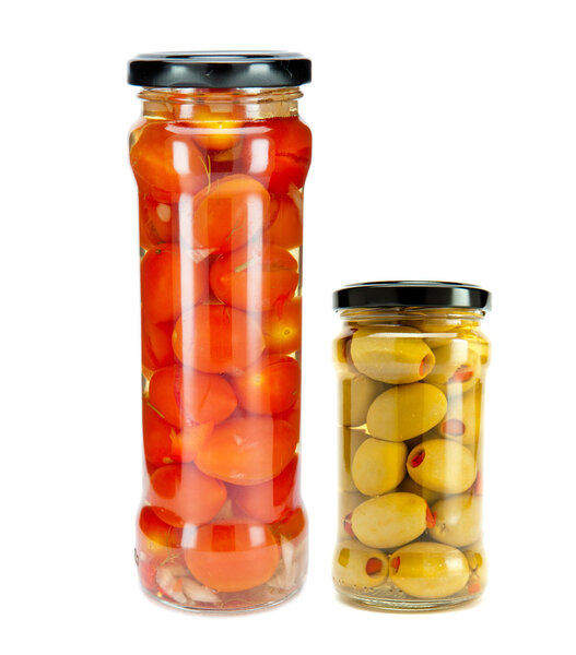 Tomatoes canned in glass jar and jar with tinned olives