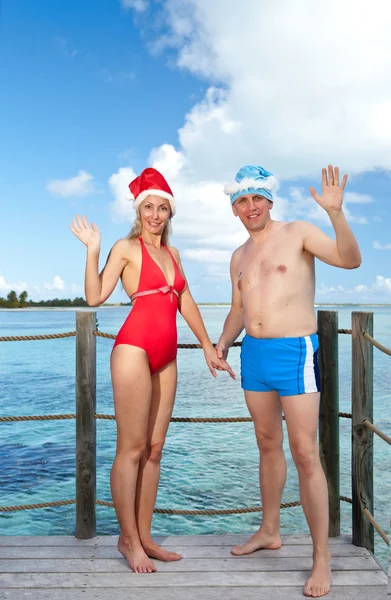 Stock image The man and the woman in New Year's suits on a beach