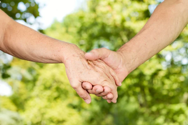 Closeup of old hands holding together — Stock Photo, Image