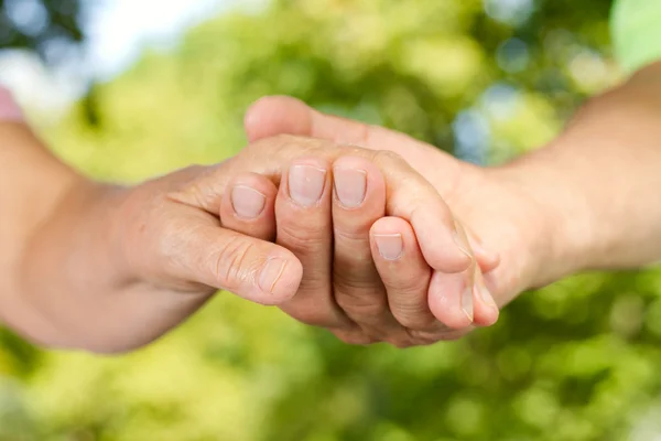 Closeup of senior hands holding together — Stock Photo, Image