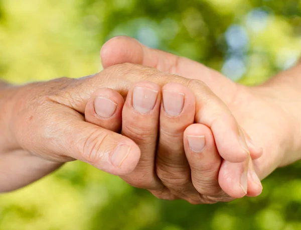 Closeup of senior hands holding together — Stock Photo, Image