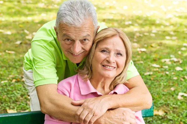 Happy elderly man embracing mature woman — Stock Photo, Image
