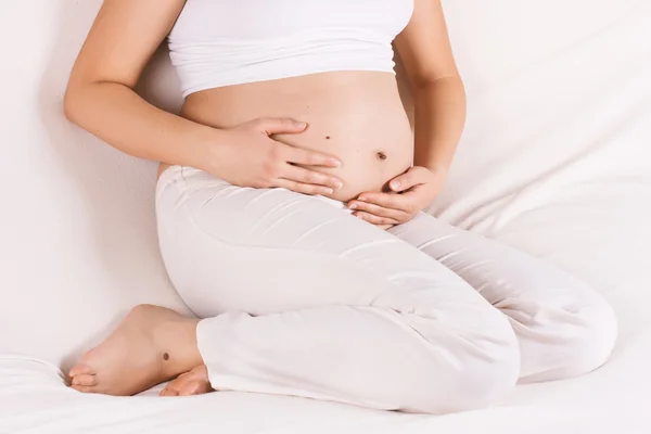 Gravid kvinna röra hennes mage — Stockfoto