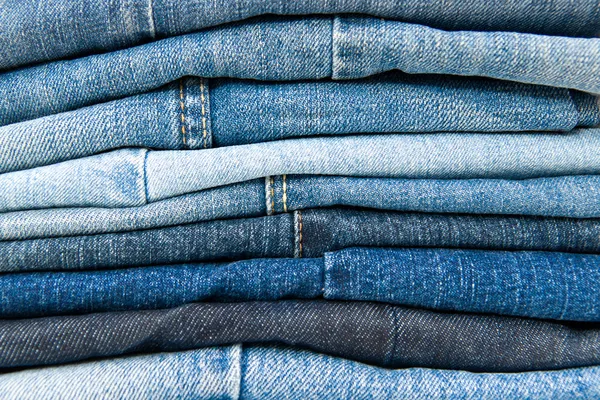 Stack of blue jeans fond — Photo