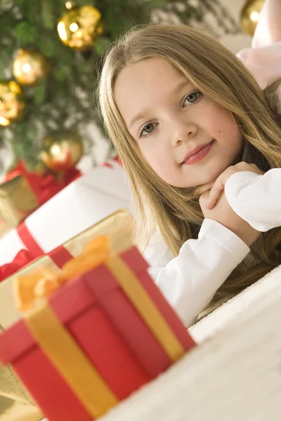 Beautiful young blonde girl with cute red gift box. Christmas tr — Stock Photo, Image