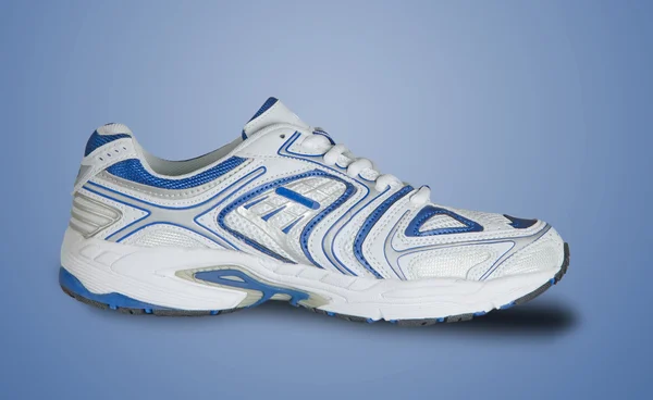Üzerinde mavi arka plan izole spor ayakkabı — Stok fotoğraf
