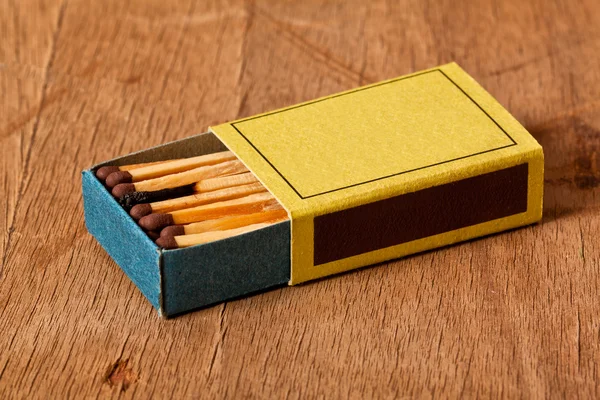 One burnt match in a full matchbox — Stock Photo, Image