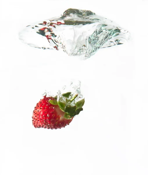 Strawberry dropped into water splash — Stock Photo, Image