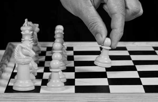 White chess pieces with hand playing — Stock Photo, Image