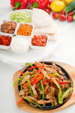 Original fajita sizzling hot on iron plate clipart