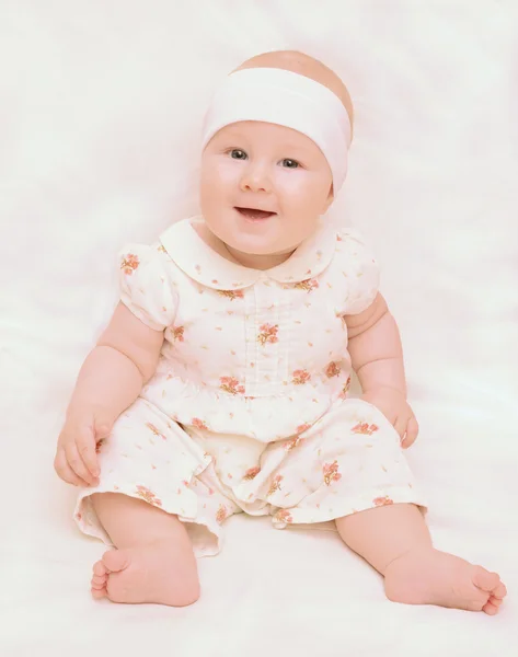 Baby girl is sitting and laughing — Stock Photo, Image