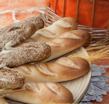 Loafs of browned bread with a wheat twig clipart