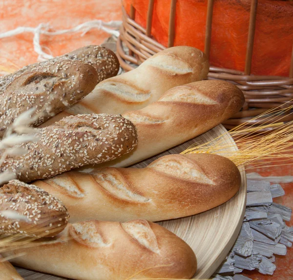 stock image Loafs of browned bread with a wheat twig