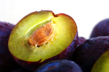 Half of plums isolated on white background clipart