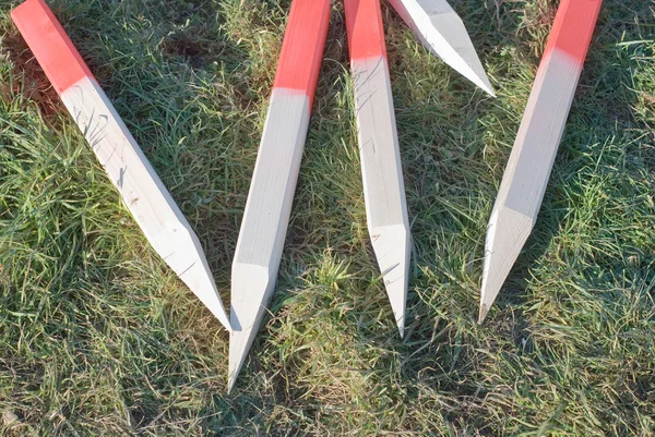 Collection of Stakes in the Grass — Stock Photo, Image
